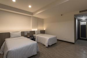 Säng eller sängar i ett rum på Lotus Yuan Business Hotel