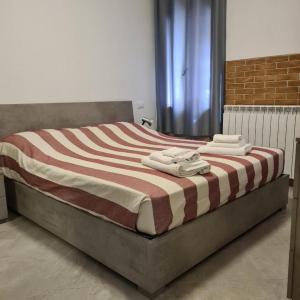 a bed with a striped blanket on top of it at VENEZIA BEACH e CHIOGGIA PLAYA in Chioggia