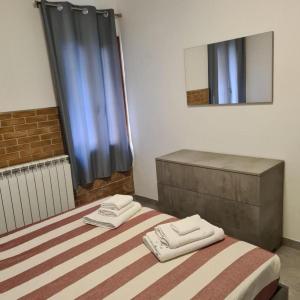 a bedroom with a bed with two towels on it at VENEZIA BEACH e CHIOGGIA PLAYA in Chioggia +49 photos