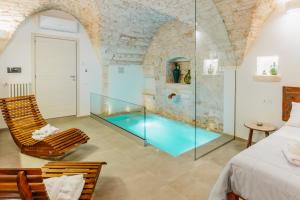 a room with a swimming pool and a bedroom at Gattoni Suite by Rentbeat in Martina Franca