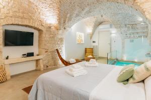 a bedroom with a bed and a swimming pool at Gattoni Suite by Rentbeat in Martina Franca