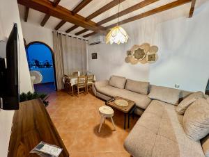 a living room with a couch and a table at Andalucia Family-Only Aparthotel in Cabo Negro