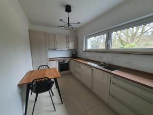 a kitchen with a wooden table and a counter top at HomeComfort in Cologne