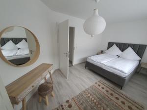 a small bedroom with a bed and a mirror at HomeComfort in Cologne