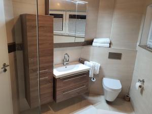 a bathroom with a toilet and a sink and a shower at HomeComfort in Cologne