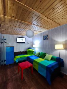 a living room with a couch and a table at OliMarii domki nad jeziorem Jezioro Złotnickie Karłowice 19 a,b in Karłowice