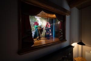 a painting of three dolls on a wall at Etna Quota Mille Boutique Hotel, Typical Sicilian Food & Wine in Randazzo +60 photos