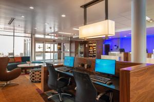 an office with two computers on a desk with chairs at Fairfield Inn & Suites by Marriott Sidney in Sidney +65 photos