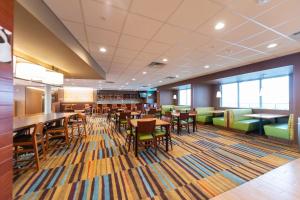 a dining room with tables and chairs at Fairfield Inn & Suites by Marriott Sidney in Sidney
