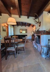a dining room with a table and a fireplace at Villa DORA in Vrbovsko