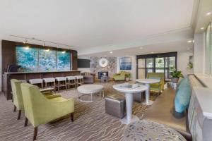 a waiting room with yellow chairs and tables at Best Western Plus Agate Beach Inn in Newport