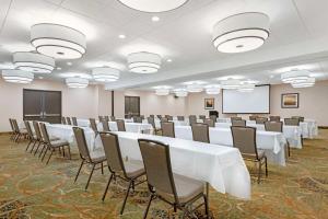 a conference room with white tables and chairs and a whiteboard at Best Western Plus Agate Beach Inn in Newport +100 photos