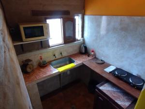 a small kitchen with a sink and a window at Cabañas "Los Elementos", San Carlos, Salta, in San Carlos