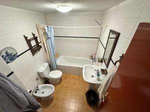 a bathroom with a sink and a toilet and a tub at Casona de la Tauna in Sos del Rey Católico +32 photos