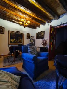 a living room with a blue couch and a table at Casona de la Tauna in Sos del Rey Católico