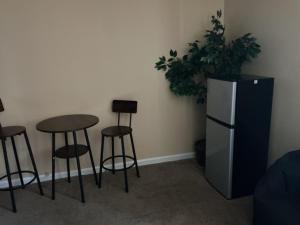 a room with a table and stools and a refrigerator at Guest Suites in Conley +28 photos