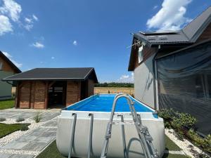 a swimming pool in a yard next to a house at Noclegi Dąbek in Rymanów