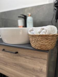 a basket of towels on a counter in a kitchen at Etno Lux Isaković in Ulcinj