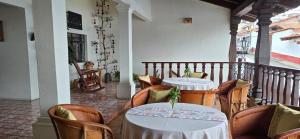 a restaurant with two tables and chairs and a balcony at Casa Vielma in Tapalpa