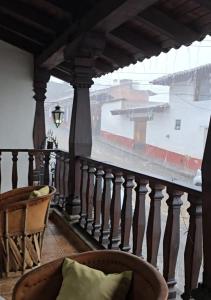 a balcony with a view of a building in the rain at Casa Vielma in Tapalpa