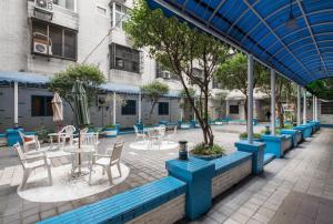 a patio with tables and chairs in a courtyard at Lotus Yuan Business Hotel in Zhongli