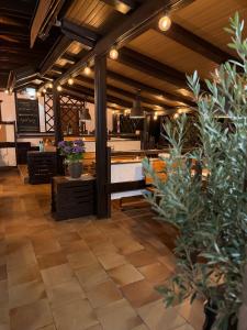 a dining room with a table and some plants at RESTAURACE A PENZION U DOUBKŮ in Břeclav