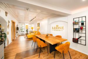 a dining room with a wooden table and orange chairs at 120m2 l Golden Castle Loft l Old Town l Thun in Thun