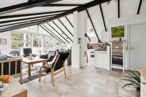 a kitchen and living room with white walls and beams at 1395-Thisted-Revlingvej-5 in Nørre Vorupør