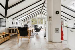 a kitchen and living room with a table and chairs at 1395-Thisted-Revlingvej-5 in Nørre Vorupør +10 photos