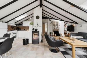 a living room with a table and chairs and a fireplace at 1395-Thisted-Revlingvej-5 in Nørre Vorupør