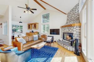 a living room with a couch and a fireplace at Pinetree Palace in Lake Arrowhead