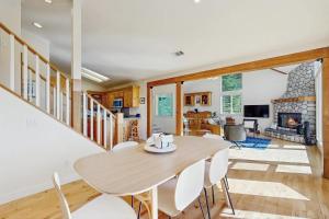 a dining room with a table and chairs and a fireplace at Pinetree Palace in Lake Arrowhead