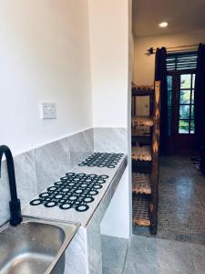 a kitchen with a sink and a counter top at Cheff Hotel Vianuel in Kendwa