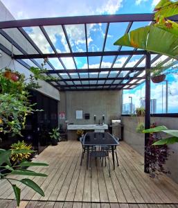 a patio with a table on a wooden deck at Nunciatura Centrico in San José