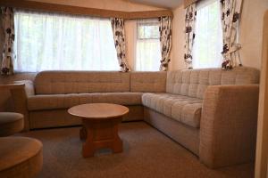 a living room with a couch and a table at Kota Kiva in Hulshorst