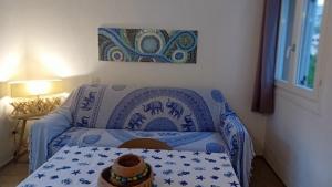 a blue couch with a hat on it in a room at Appartamento "Hic et Nunc" in Costa Paradiso