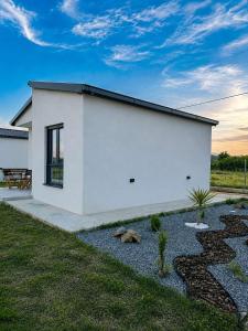 a white building with a patio and a yard at Etno Lux Isaković in Ulcinj +20 photos