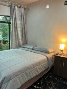a bedroom with a large bed with a window at casa borde de lago4 in Panajachel