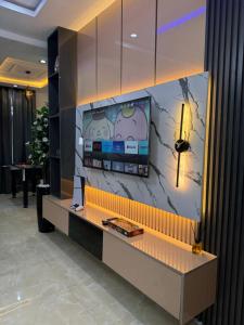 a tv on a wall in a lobby at 2bedroom Harmony Apartment in Abuja