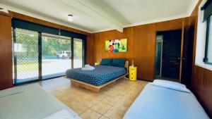 a bedroom with two beds in a room with a window at Ammaboolah at Hat Head - 36 Hutcheson Street in Hat Head