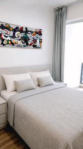 a bedroom with a bed and a painting on the wall at Beach Pool Hotel Punta Cana in Punta Cana