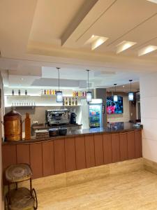 a bar in a restaurant with a counter and a counter at Hotel Rama in Oued Laou