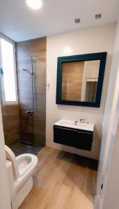 a bathroom with a toilet and a sink and a mirror at Beach Pool Hotel Punta Cana in Punta Cana
