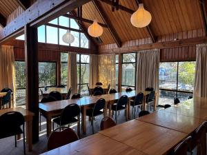 a large room with tables and chairs and windows at Cedar Chalets and Barkers Lodge in Methven