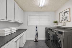 a laundry room with a washing machine and a window at Vail Pines Stay in Vail +3 photos