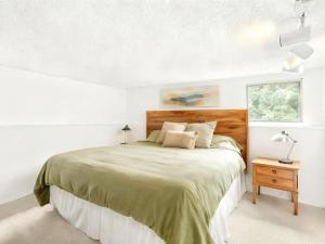 a bedroom with a large bed and a window at Vail Pines Stay in Vail