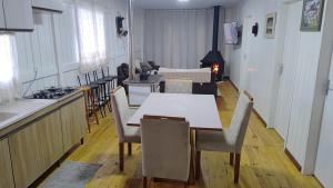 a kitchen and dining room with a table and chairs at Casa de Campo Bella Vista in Urupema
