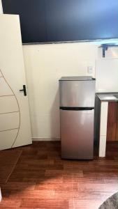 a kitchen with a refrigerator in a room at Studio completo, perto da praia! in São Luís