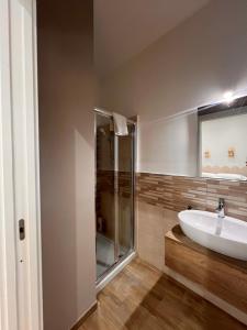 a bathroom with a sink and a shower at Eirenè Peaceful Suites in Agrigento +51 photos