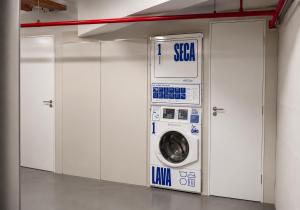 a washer and dryer in a room with white cabinets at Hotel & Residence Sol Alphaville Flat in Barueri +22 photos